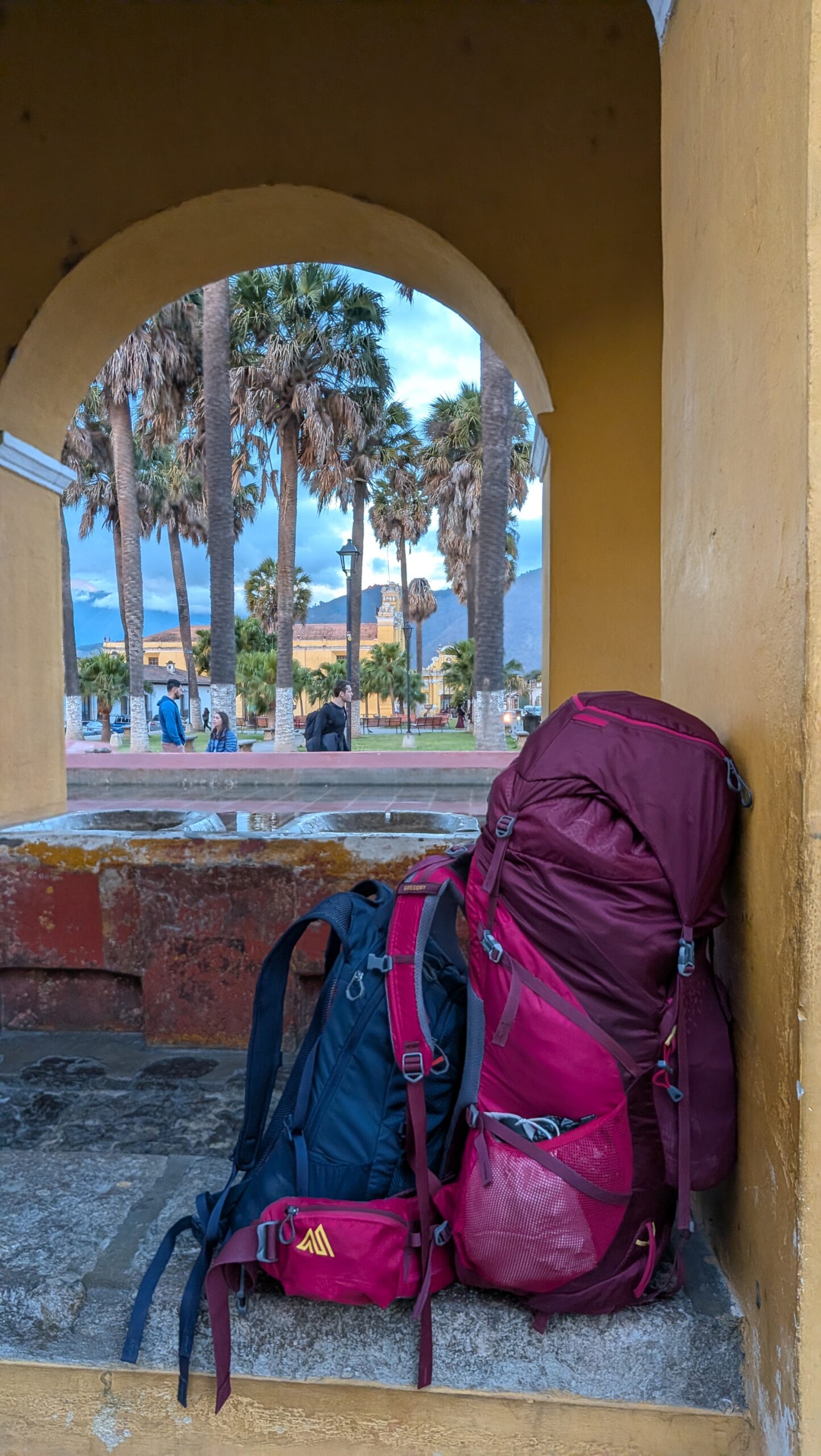 Gregory 60L backpack, packed and standing next to a trailhead sign