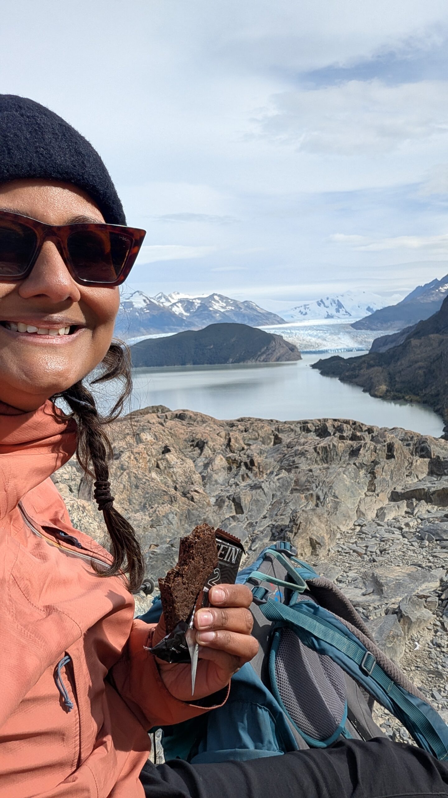 Solo traveler pausing on a trail overlook, mid-journey