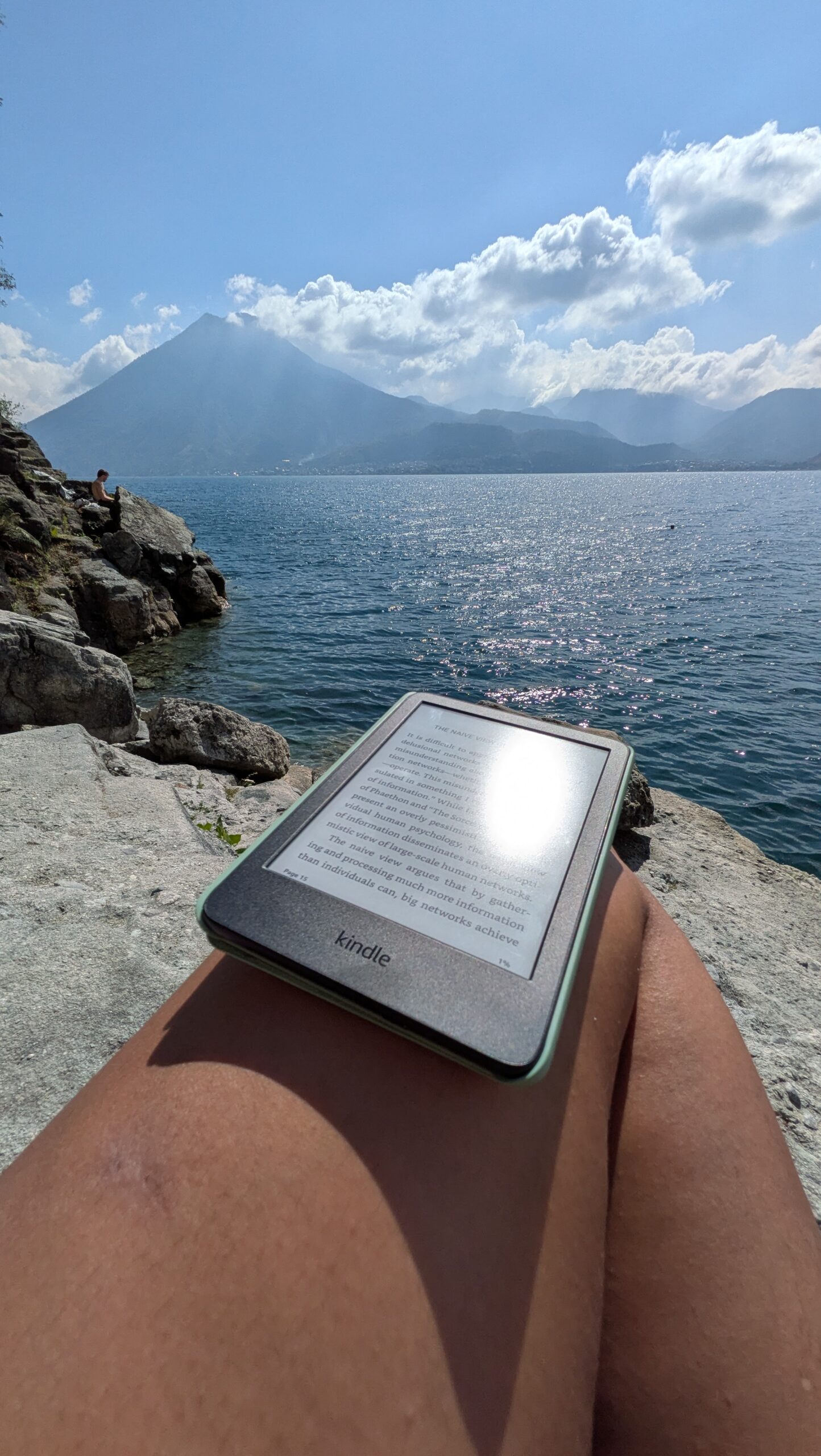 Kindle and journal on a hotel bed or plane tray table