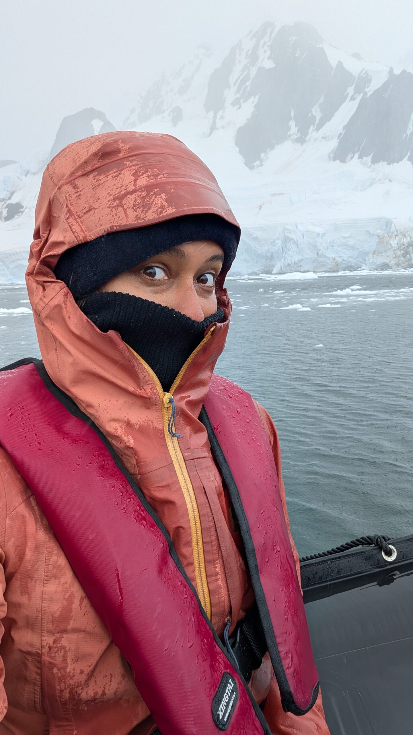 Fleece or rain jacket against a mountain or overcast backdrop