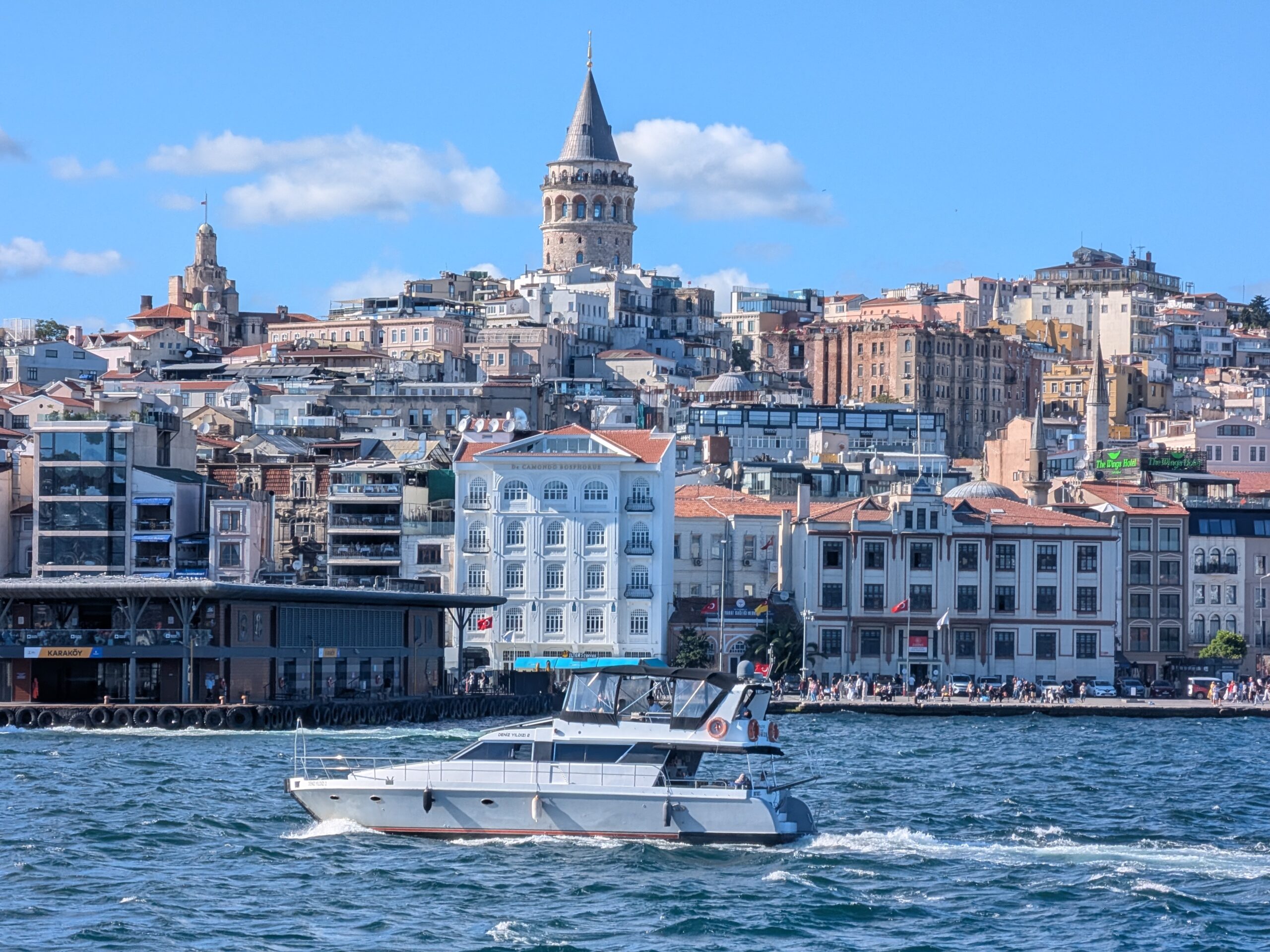 Galata Tower at dusk, ferries crossing the Bosphorus